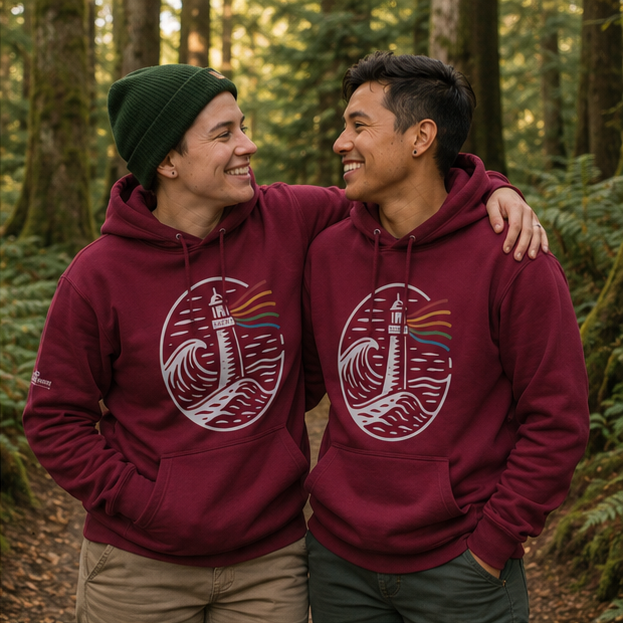 A Beacon Always Burns Hoodie at a Pacific Northwest forest trail — queer-owned PNW Pride apparel, front view