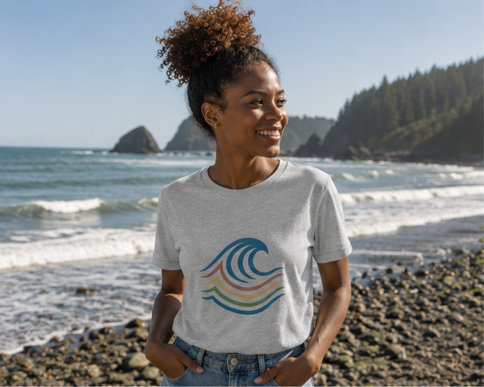 BreakWater T-Shirt on the bright rocky Pacific Northwest coast — queer-owned PNW Pride apparel, front view