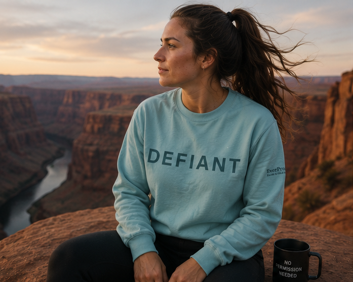 Defiant Sweatshirt at an Eastern Washington canyon — queer-owned PNW Pride apparel, front view