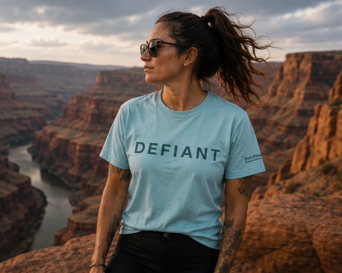 Defiant T-Shirt at an Eastern Washington canyon — queer-owned PNW Pride apparel, front view