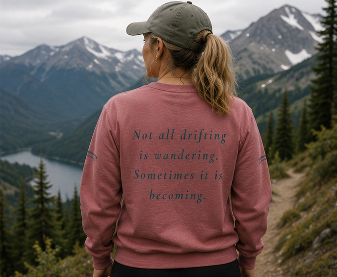 Drift Sweatshirt on an alpine trail — queer-owned PNW Pride apparel, back view with inspirational quote