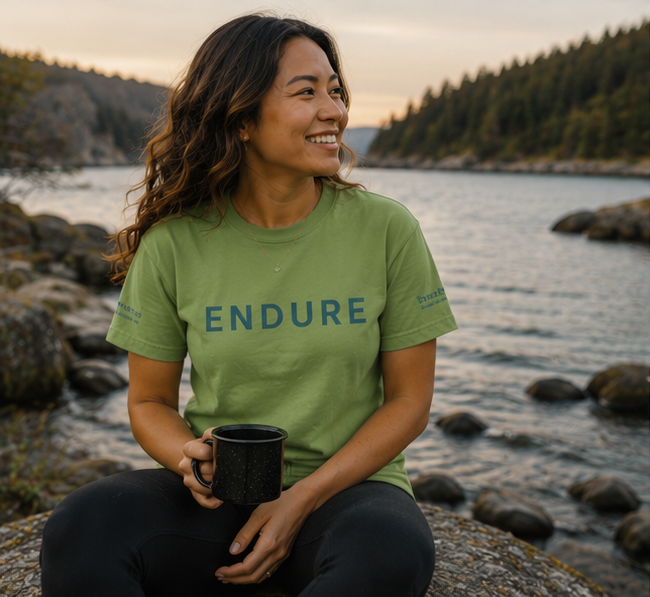 Endure T-Shirt at a Pacific Northwest lakeside — queer-owned PNW Pride apparel, front view