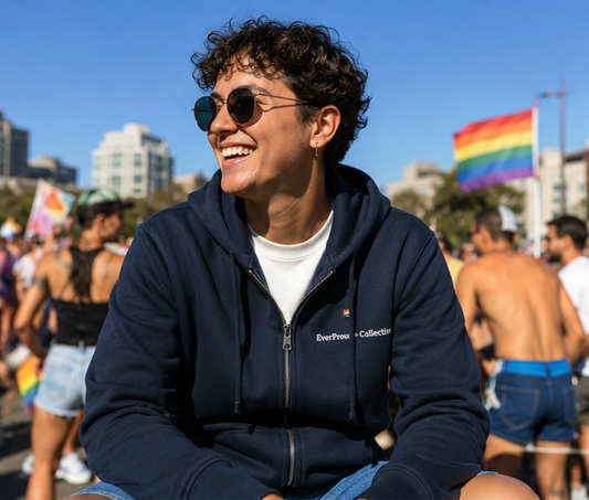 EverProud Logo Minimalist Zip Hoodie at a sunny Pride community gathering — queer-owned PNW Pride apparel, front view
