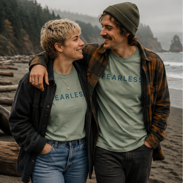 Fearless T-Shirt on a misty Pacific Northwest beach — queer-owned PNW Pride apparel, front view