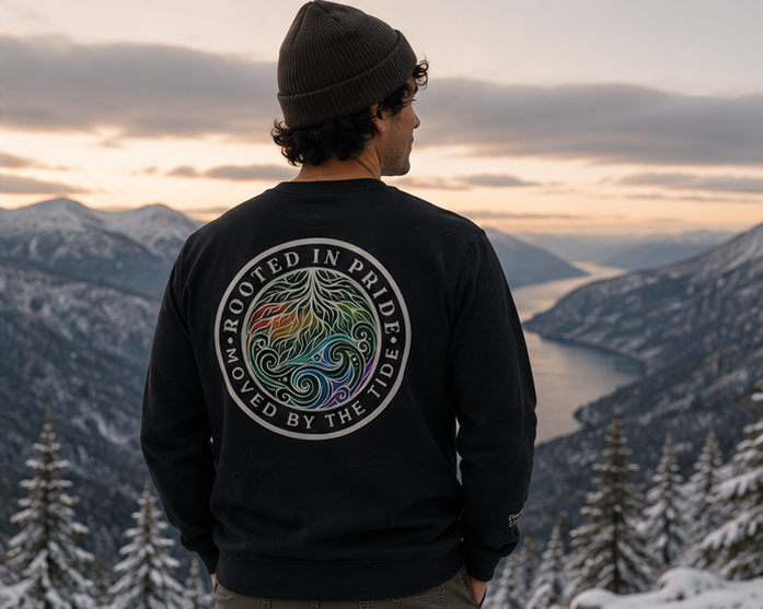 Moved by the Tide Sweatshirt on a frosty Pacific Northwest coastline in winter — queer-owned PNW Pride apparel, back view