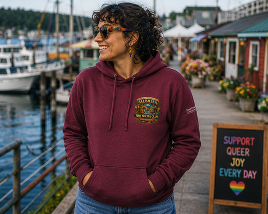 Pride on the Tide Hoodie at a Pacific Northwest marina market — queer-owned PNW Pride apparel, front view
