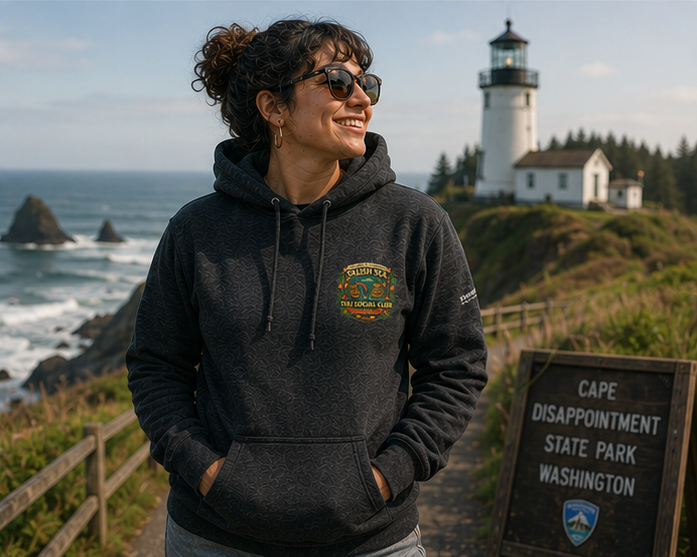 Pride Punch Hoodie at Cape Disappointment Lighthouse — queer-owned PNW Pride apparel, front view