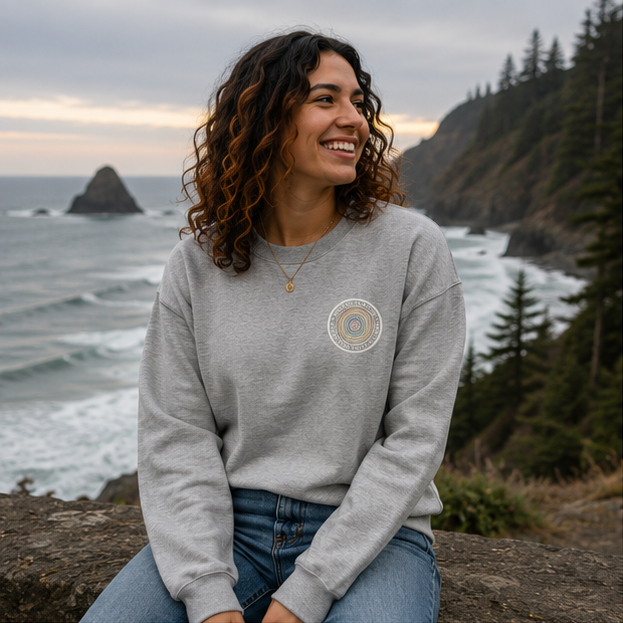 Quiet Rings Sweatshirt on a Pacific Northwest coastal overlook — queer-owned PNW Pride apparel, front view