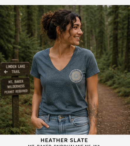 Quiet Rings Women's Relaxed V-Neck T-Shirt at a Pacific Northwest forest trail — queer-owned PNW Pride apparel, front view