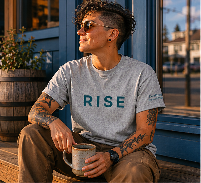 Rise T-Shirt at a Pacific Northwest small-town coffee shop — queer-owned PNW Pride apparel, front view