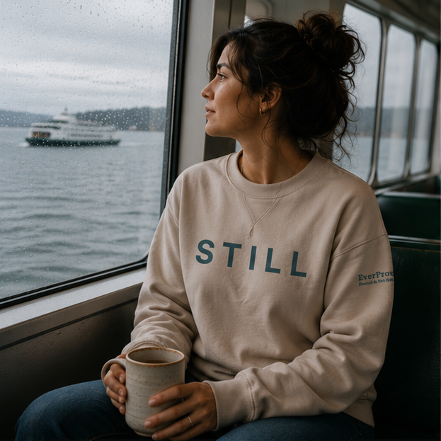 Still Sweatshirt at a Pacific Northwest ferry window — queer-owned PNW Pride apparel, front view