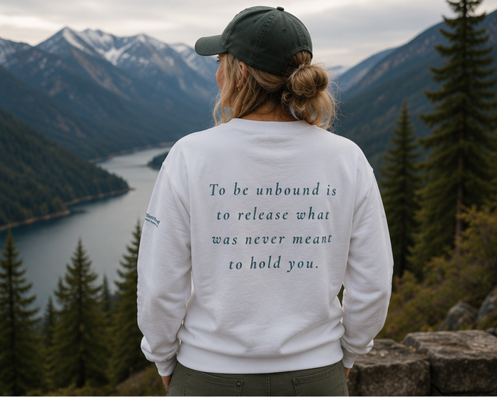 Unbound Sweatshirt at a misty Pacific Northwest mountain lake — queer-owned PNW Pride apparel, back view with inspirational quote