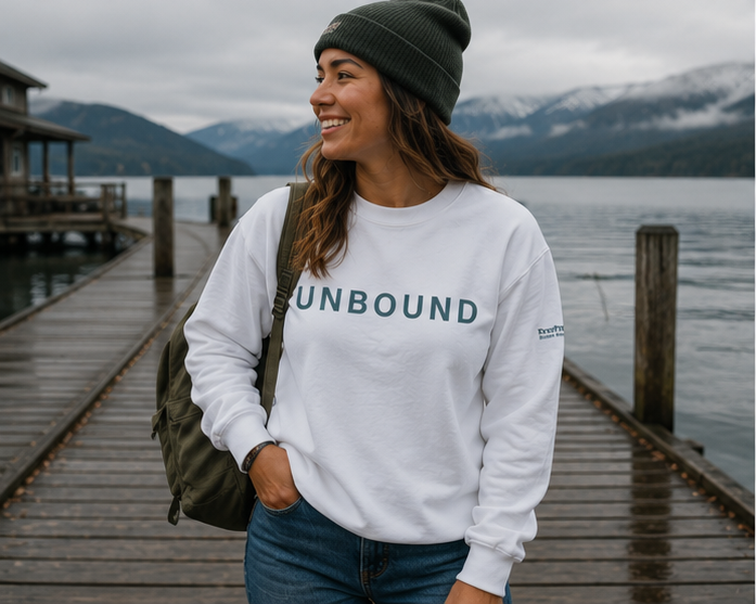 Unbound Sweatshirt at a Pacific Northwest lakeside dock — queer-owned PNW Pride apparel, front view