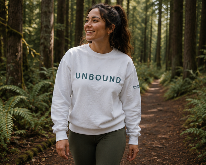 Unbound Sweatshirt at a Pacific Northwest forest trail — queer-owned PNW Pride apparel, front view