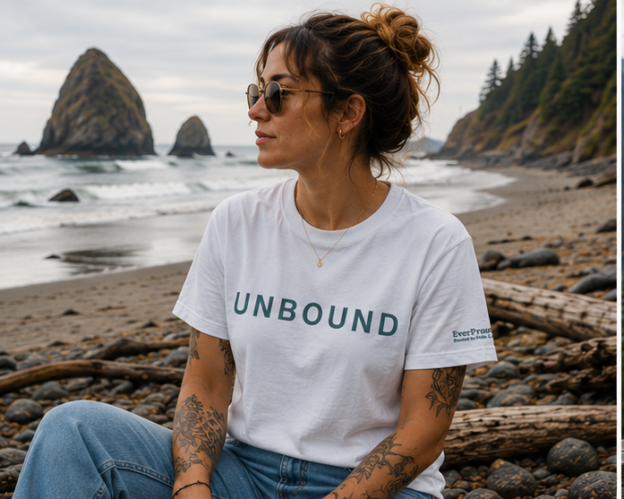 Unbound T-Shirt worn on the rocky Pacific Northwest coast — queer-owned Pride graphic tee, front view